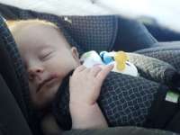 Kisbaba autós hordozóban alszik